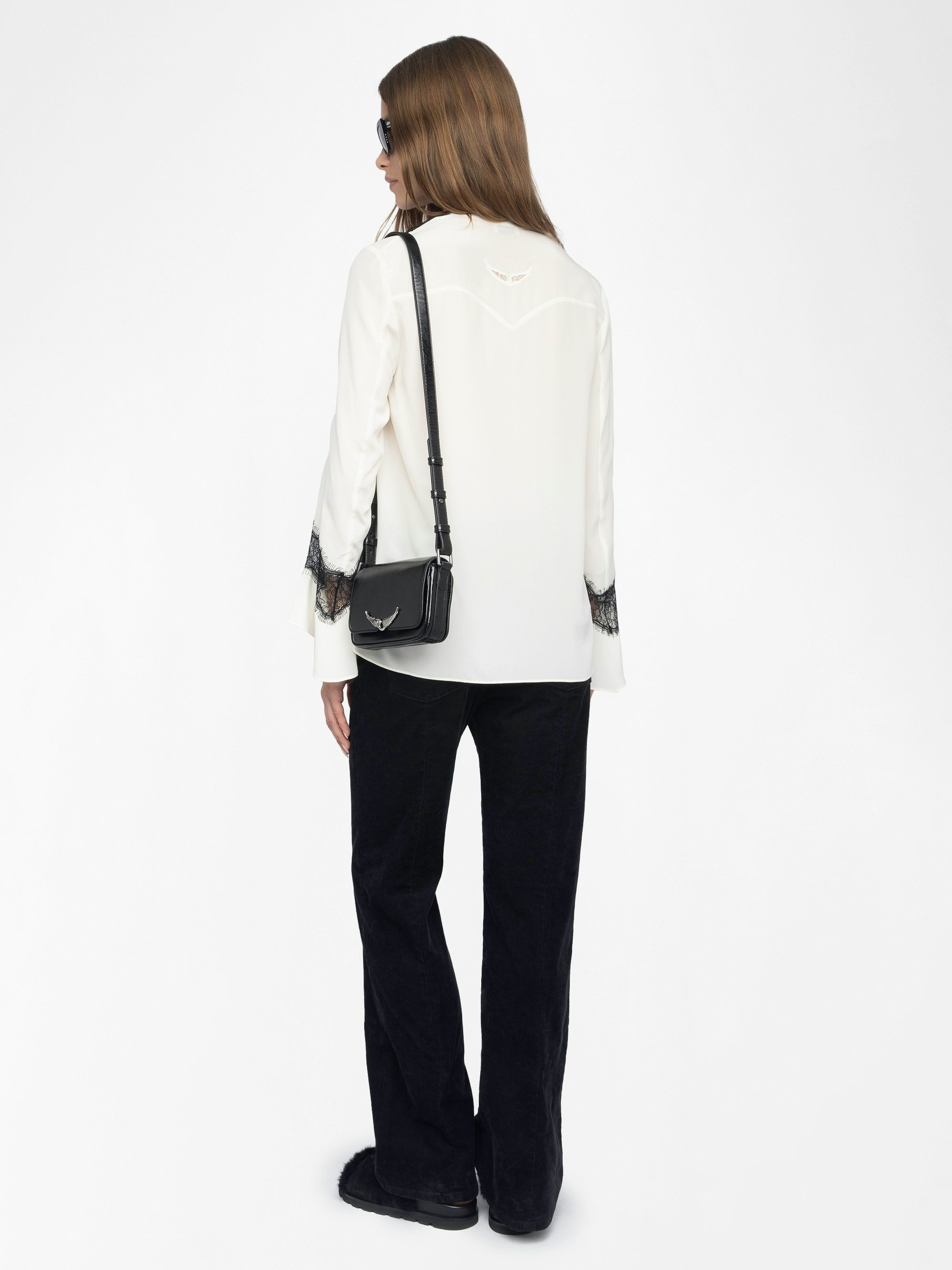 Tuan Lace Shirt - The Tuan shirt plays contrast with a soft ivory silk and bold black lace trim. Effortlessly sensual, it drapes with attitude—open neckline, flared cuffs, and just the right amount of rebellion.